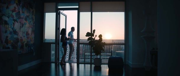 Couple going onto a balcony at dusk