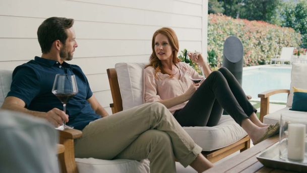 Woman and man sitting on the porch with a glass of wine