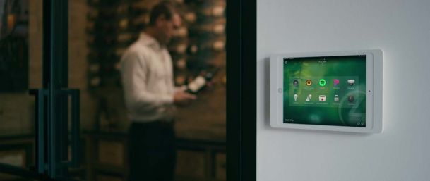 Man in a wine cellar with a control4 ipad on the wall
