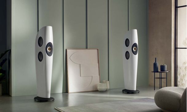 Kef blade speakers in front of a mint green wall